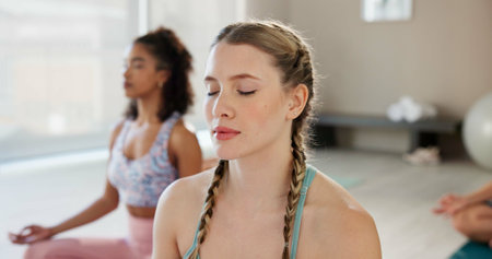 Meditation, breathing and zen with women in class for health, pilates and wellness. Yoga balance, mindfulness and spiritual healing with people and holistic practice for relax, awareness or energyの写真素材