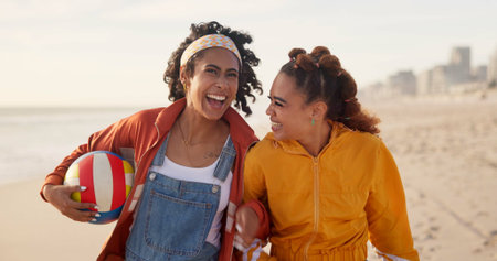 Women, beach and outdoor laughing with ball, freedom and weekend trip to ocean waves. Friends,...