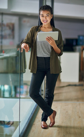 Tablet, portrait and confident in office, woman and professional in night, online and deadline of reporter. Proud, research and person with app, working late, journalist and smile in newsroomの写真素材