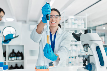 Dropper, happy woman or scientist in laboratory for particles, clinical trial or chemical discovery....