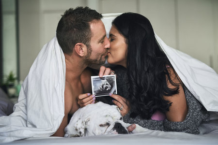 Bed, couple and kiss with sonogram of ultrasound, progress and growth for baby development. Bedroom,...