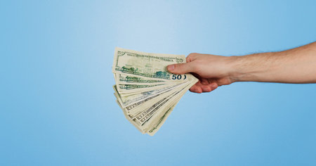 Money fan, dollars and hand of person in studio with offer, bonus or prize giveaway for financial...