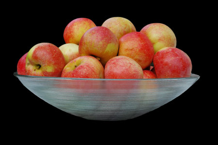 Apple, diet and bowl on black background for nutrition, eating and healthy food with sustainability. Fruit, container and harvest in studio for vitamin C, hydration and eco friendly agricultureの写真素材