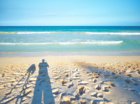 Person, view and ocean with shadow on sand for vacation and environment to relax in Brazil. Adventure, explore and landscape of island, sea and beach in Rio de Janeiro destination for outdoor travelの写真素材