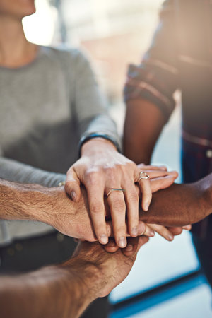 Employees, hands and stack in circle for team building, office support and motivation for goals. Creative business people, pile diversity and huddle for workplace collaboration, solidarity or meetingの写真素材