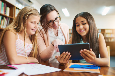 Teacher, children and digital with tablet for education, elearning and math game for numbers solving skill. School, educator and students in elementary for knowledge, multiplication and studying appの写真素材