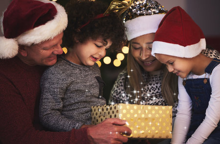 Christmas, grandparents and kids with gift, house and bonding together with festive season, smile and holiday. Xmas, family and children with surprise, love and present with vacation and celebrationの写真素材