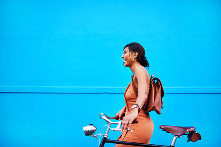 Bicycle, adventure and woman by wall in city for sustainable transport for travel, journey or...