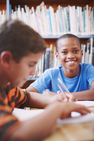 Smile, black child and education with books in library for assessment research, learning notes and...