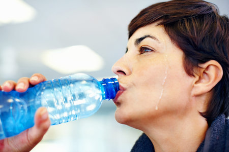 Fitness, sweat or woman drinking water for health, wellness or nutrition with face profile in gym....