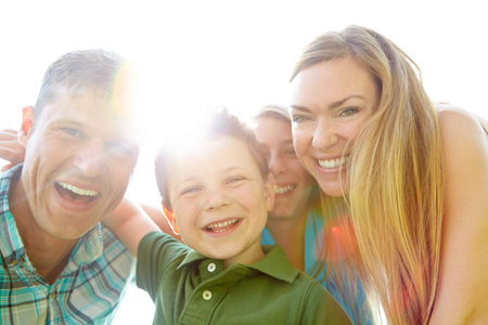 Portrait, park and parents with kids, hug and bonding together with smile, funny and love. Face,...