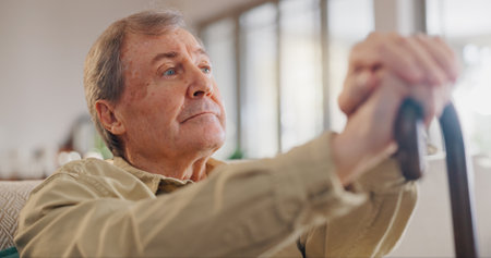 Walking stick, ideas and senior man in home with dementia in nursing home with sickness. Alzheimers, cane and elderly male person with disability in retirement for medical assisted living facility.の写真素材