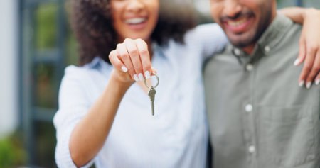 Couple, hands and new home with keys, love and smile together from property investment outdoor....
