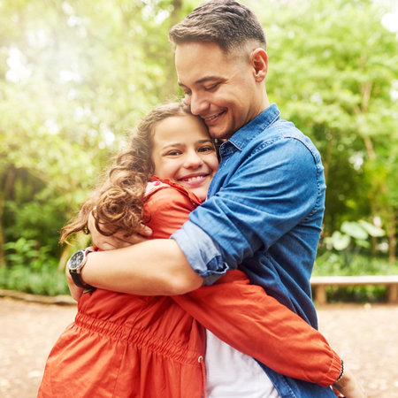 Outdoor, dad and girl in portrait with hug, love and bonding together on fathers day in park. Happy people, papa and teen child with connection embrace for gratitude, affection and care in backyardの写真素材