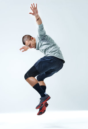 Fitness, man and jump with exercise in studio for healthy body, workout and muscle strength. Person,...