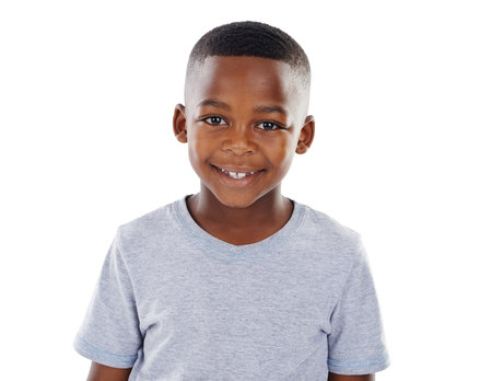Smile, relax and portrait of black child in studio for cheerful, positivity and development in youth. Happy, calm and face of boy with confidence for joyful, innocence and growth by white backgroundの写真素材