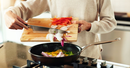 Hands, frying pan and cooking as chef in kitchen for diet or recipe in home with satisfaction. Person, culinary art for gourmet cuisine, creative or nutritionist for meal preparation, dinner and foodの写真素材