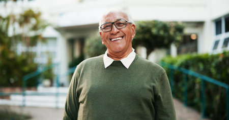 Portrait, smile and senior man outdoor by nursing home for wellness, health or life insurance....