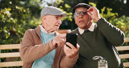 Outdoor, help and senior men with smartphone, typing and retirement with advice, texting and...