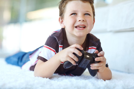 Home, child and smile with controller for video game, playful and entertainment for childhood by...