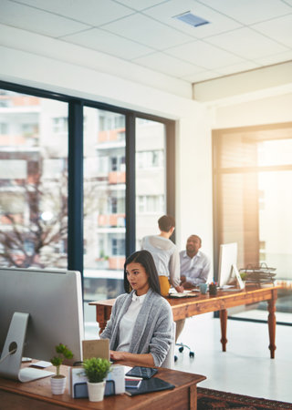 Office, businesswoman and planning with computer for typing, editing and thinking for story angle. Journalism, female editor and publication with digital for research, proofreading and online articleの写真素材