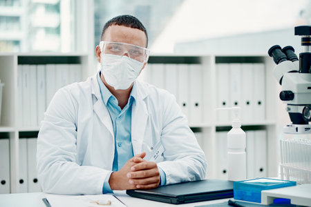 Portrait, laptop and man with mask, doctor and research for science, healthcare and medical professional. Clinic, confident and person in lab, scientist and expert of biotechnology and glasses in USAの写真素材