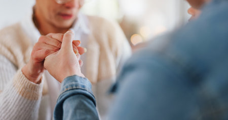 Christian, holding hands and people with prayer in home for religious healing, mercy and faith in Jesus. Forgiveness, peace and religion with fellowship for gratitude, praise and guide in Holy Spiritの写真素材