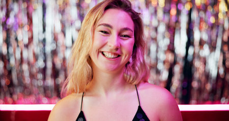 Happy, club and portrait of woman at party at night with neon lighting for celebration or fun event. Smile, confident and face of female person from London at rave, disco or dj gig for entertainmentの写真素材