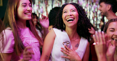 Bachelorette party, celebration and laughing with women at club for bride to be, wedding and night out. Support, bridal shower and hen do with people for social event, friends and happiness togetherの写真素材