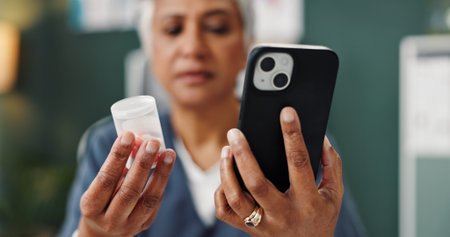 Medication, phone and hands of doctor in clinic reading information of side effects for pills....