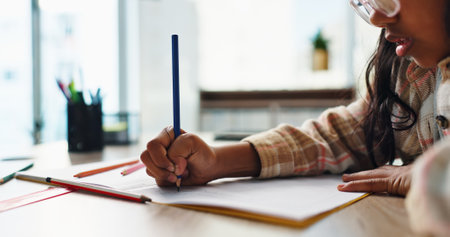 Hands, girl and kid with homework, learning and education with knowledge, drawing and notebook. Apartment, student and childhood with creativity, pencils and growth with development, study or writingの写真素材