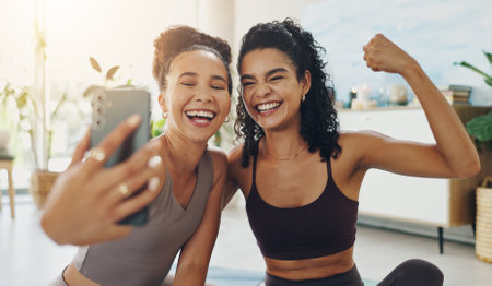 House, selfie and women with fitness, flexing and training with smile, confidence and pride. Smartphone, apartment and friends with happiness, wellness and excited with challenge, healthy and workoutの写真素材