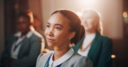 Woman, thinking or crowd in seminar for business, employee engagement or campaign information. Staff, girl or listening in conference room for presentation, productivity or feedback for developmentの写真素材
