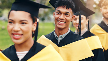 Waiting, graduation and people outdoor at university for achievement in degree, certificate or diploma. Happy, excited and man with students in line for education study goal ceremony at college.の写真素材