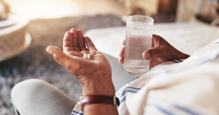Hands, water and pills for healthcare, wellness and retirement with medical problem, sick and pain. Elderly person, drink and medicine for pharmaceutical, health or illness with diabetes or arthritisの写真素材