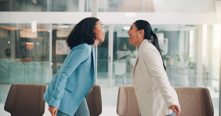 Happy, business women and laughing in office, friends and excited of deal, project and communication. Teamwork, smile and girls in boardroom, accomplishment and success of lobbyist and celebrationの写真素材