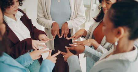 Business people, circle and hands together for teamwork, women and cooperation in modern office. Employees. coworkers and group with gesture, support and partnership with collaboration and synergyの写真素材