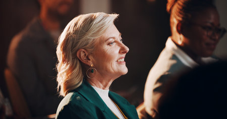 Mature woman, audience and listening for conference, presentation and business seminar with people....