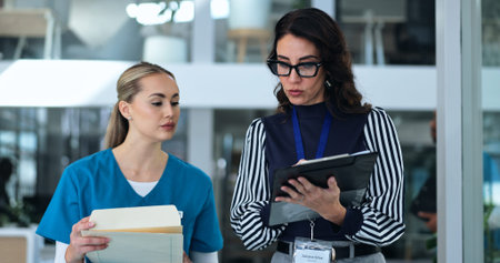 Nurse, medical team and tablet with reading, advice and discussion for surgery, patient or records....
