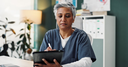 Office, woman and nurse with writing on tablet with stylus pen for patient appointments, schedule and calendar. Female person, medical professional and closeup in desk with digital notebook and diaryの写真素材