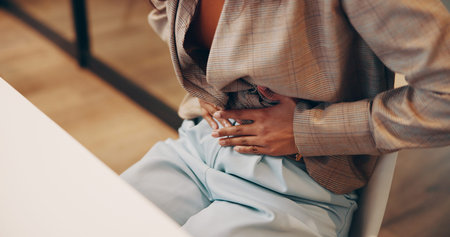 Business, woman and hands with stomach pain in office for menstrual cramps, constipation and...