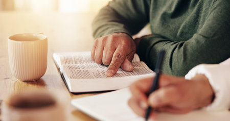 Bible, couple reading and hands writing with prayer, study and spiritual education in home. Praying,...