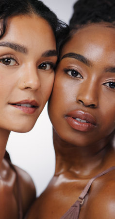 Portrait, hug and women with skincare, beauty and dermatology on white studio background. Face, friends and people with cosmetics, aesthetic and grooming routine with treatment, shine and wellnessの写真素材