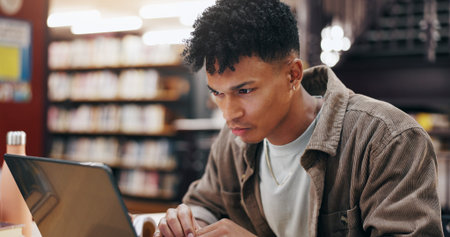 African, man and student with laptop in library for research information, university news and study...