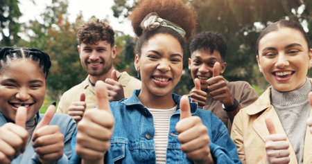 Portrait, students and thumbs up for teamwork outdoor with education support, learning and study success. People, friends and collaboration with college future, agreement and celebration for synergyの写真素材