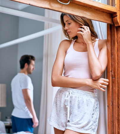 Couple, window and separation with divorce for breakup, ignore or toxic relationship at home. Young, man and woman in disagreement, argument or conflict for dispute, fight or complications at houseの写真素材