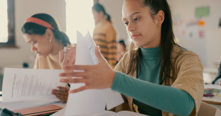 Education, school and students with notes in classroom with studying for test, exam or assignment....