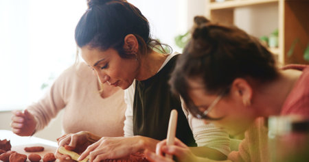 Pottery class, lesson and women with clay sculpture for molding texture, manufacturing and art product. People, workshop or creative artists learning in small business with hobby and craft projectの写真素材