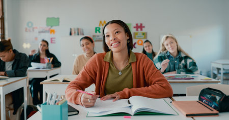 Education, smile and student with girl in classroom for learning, notebook and scholarship. Academy, knowledge and future with person in high school for solution, studying and problem solvingの写真素材