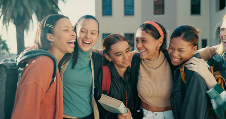 Friends, girls and students with backpack laughing together at campus for funny conversation and...